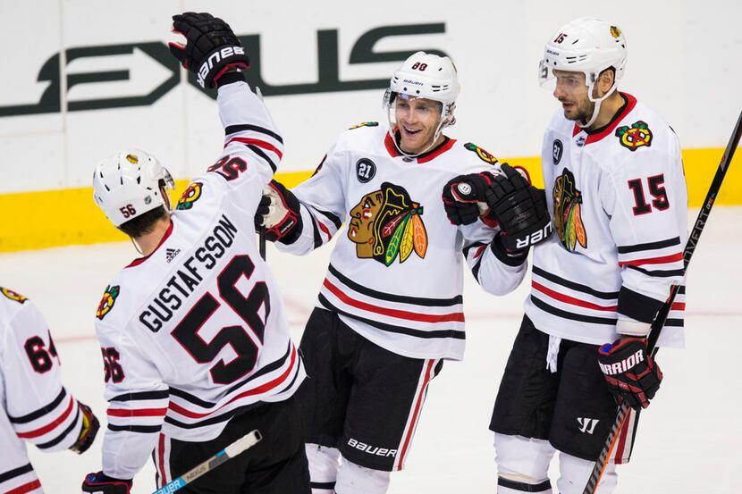 Chicago Blackhawks right wing Patrick Kane (88) celebrates with his team after scoring a...