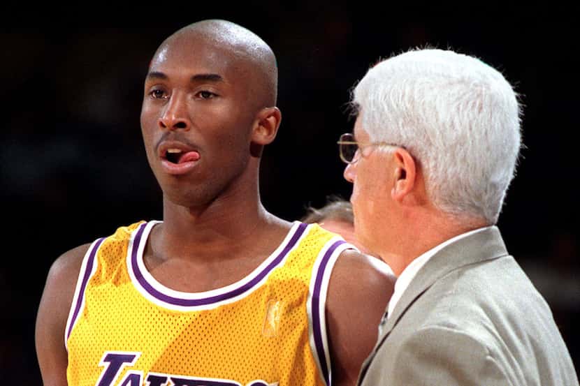 Laker rookie, 18-year-old Kobe Bryant listens to coach Del Harris during a break in the...