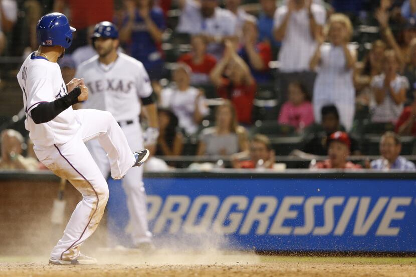 Texas Rangers second baseman Rougned Odor (73) celebrates after safely sliding into home for...