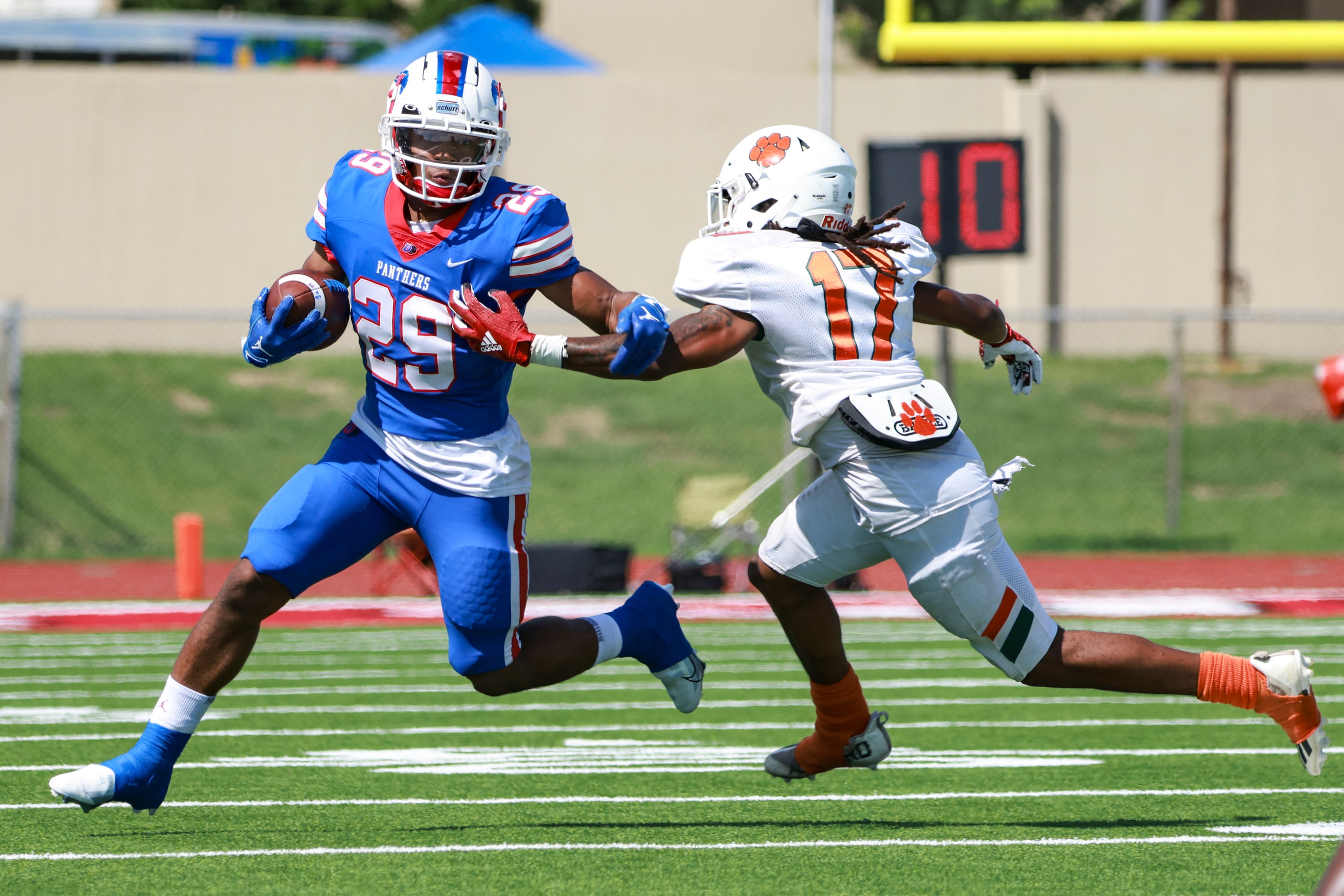 Duncanville High School Caden Durham (29) avoids Jones High School Adrian Jackson (17) while...