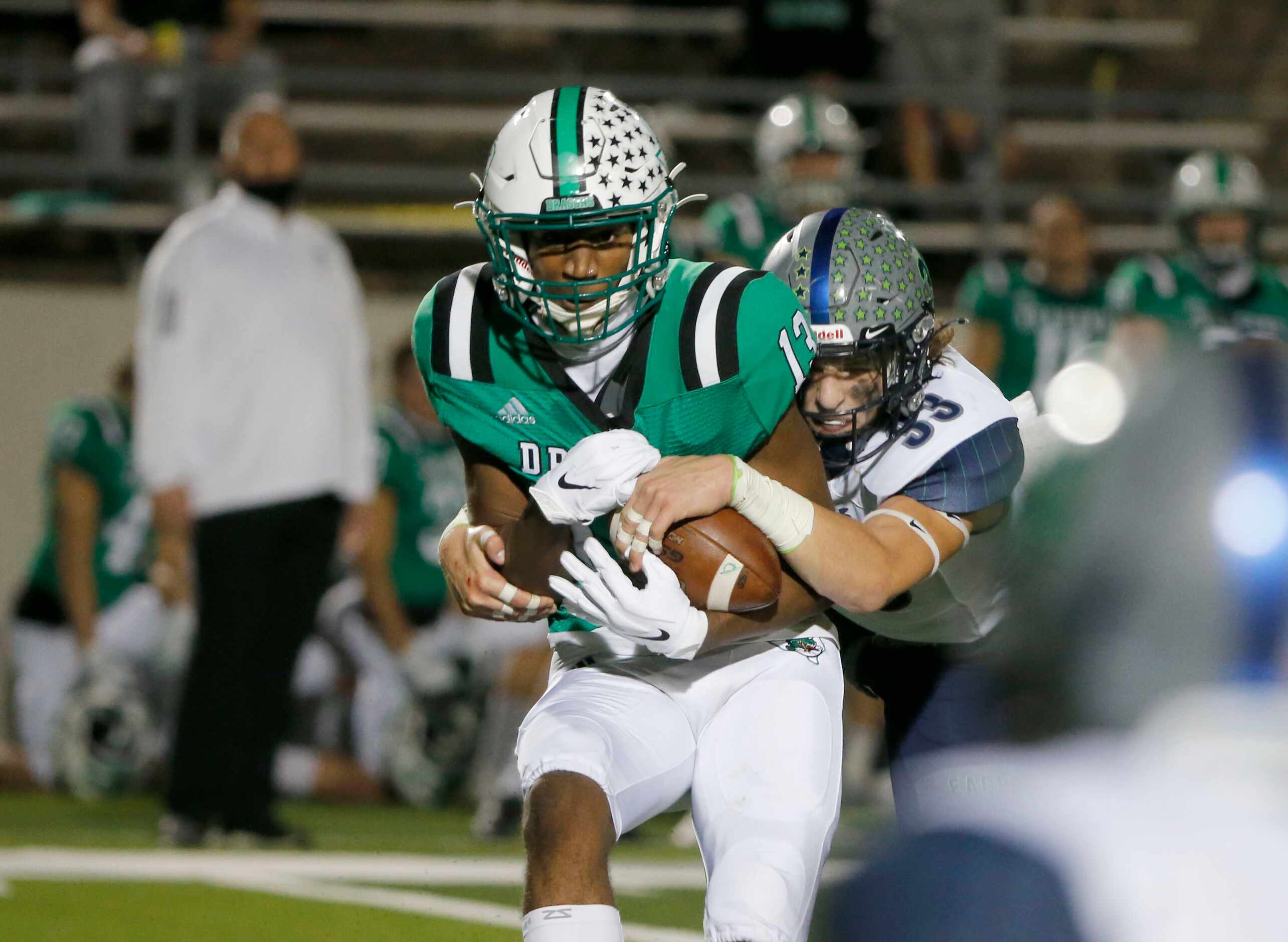 Southlake receiver R.J. Maryland (13) makes a reception and is hit by Eaton safety Ben...
