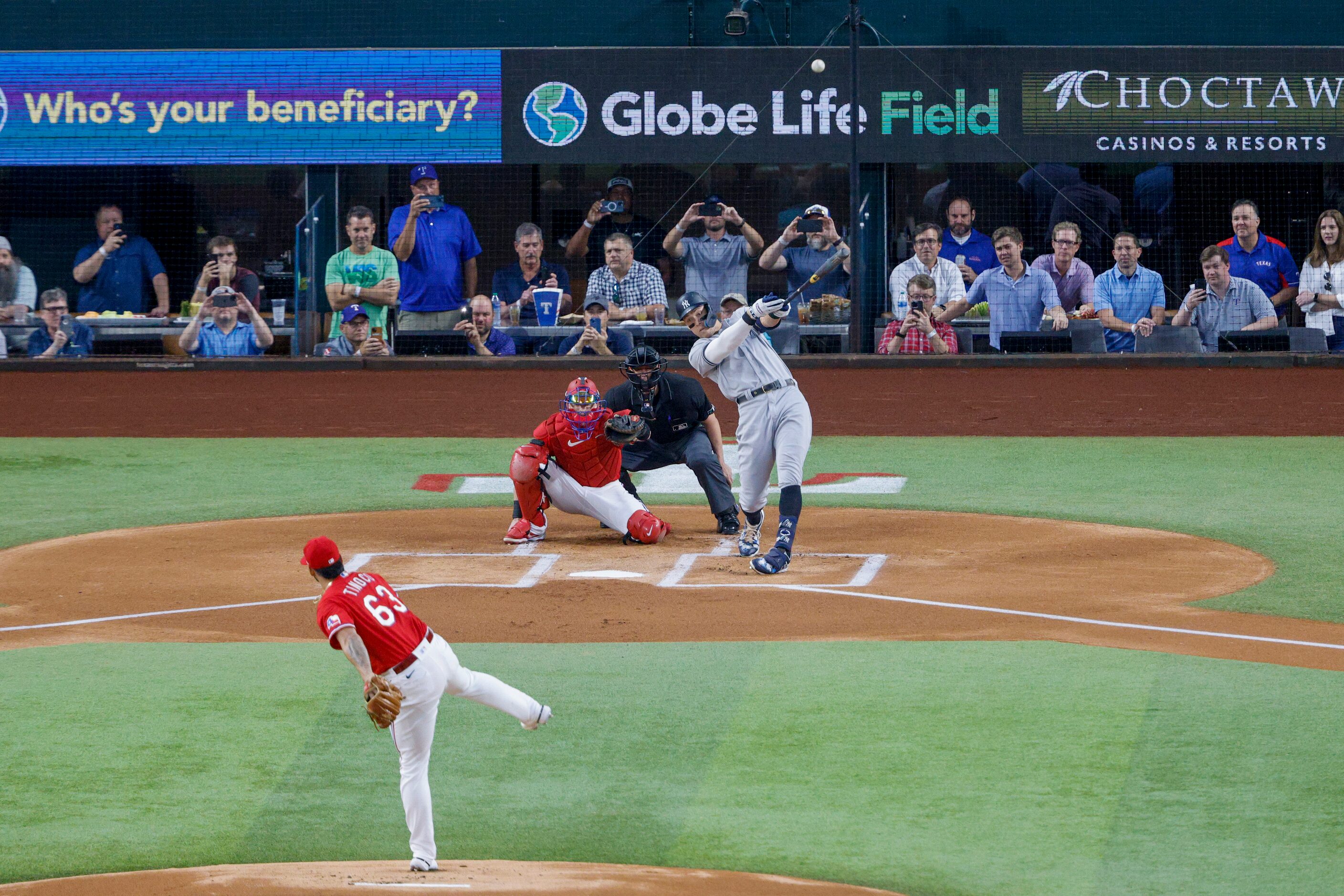 New York Yankees right fielder Aaron Judge (99) hits a home run to left field off Texas...