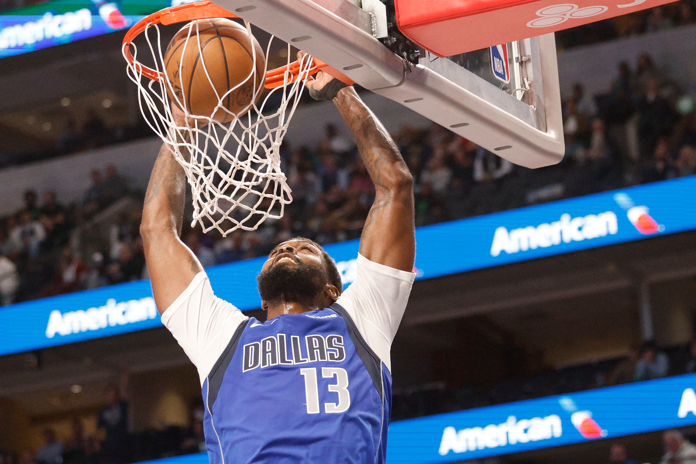 Dallas Mavericks forward Naji Marshall (13) dunks during the first half of an NBA basketball...