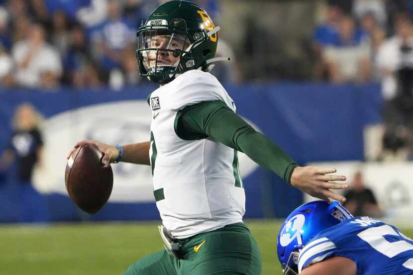 Baylor quarterback Blake Shapen (12) looks to pass the ball as BYU defensive lineman Fisher...