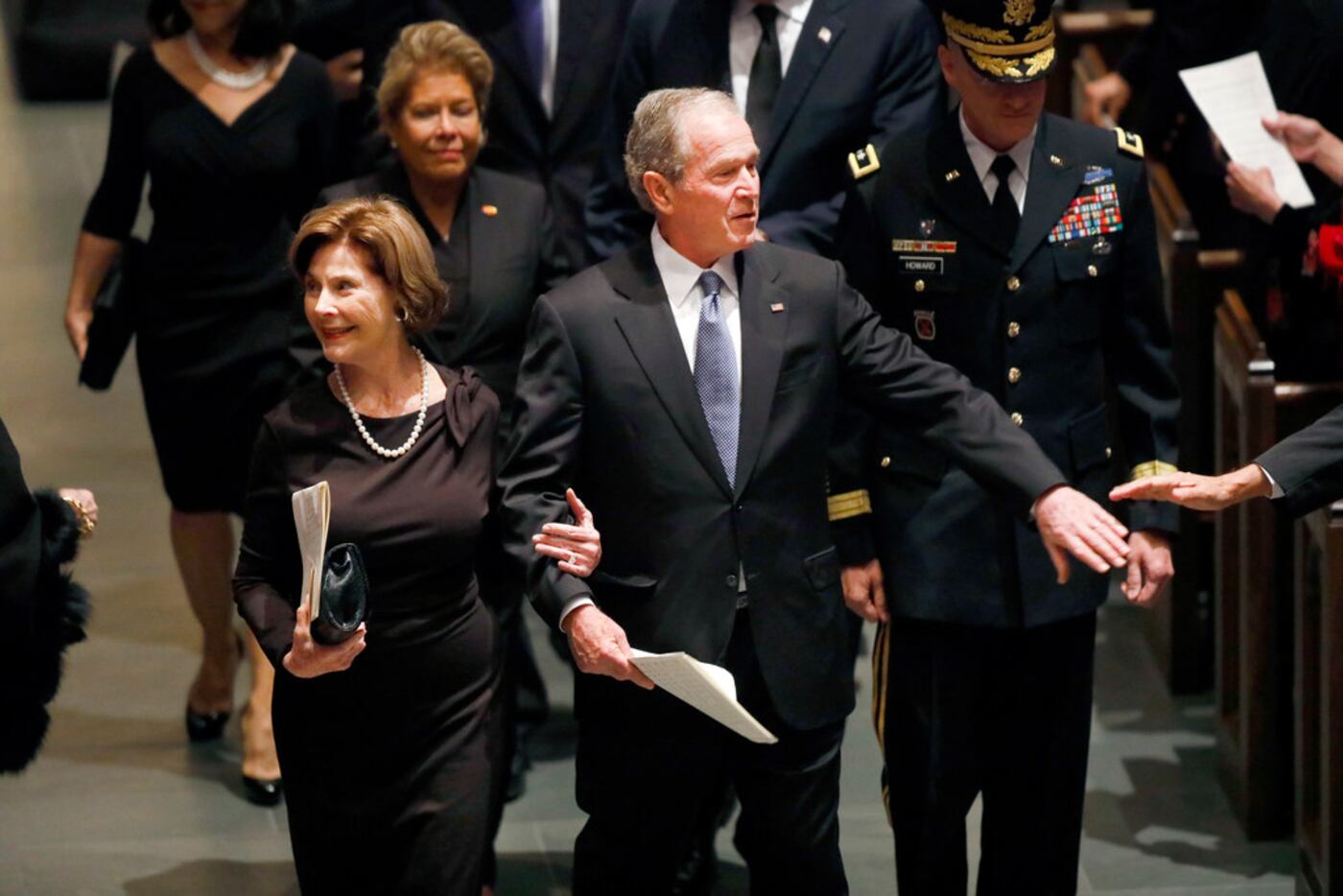 Former President George W. Bush and Laura Bush were greeted by well-wishers during the...