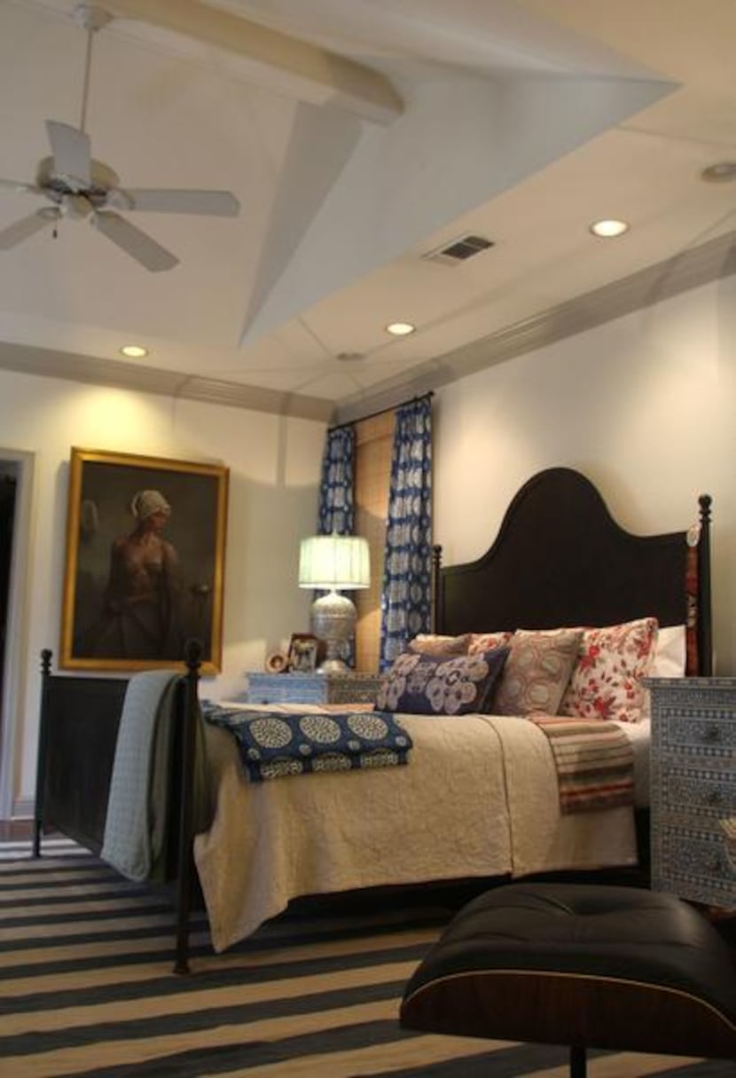 
Williams piles pillows and other colorful textiles onto the bed in the master bedroom.
