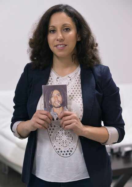 Sara Mokuria, Mothers Against Police Brutality co-founder, holds a picture of her father,...