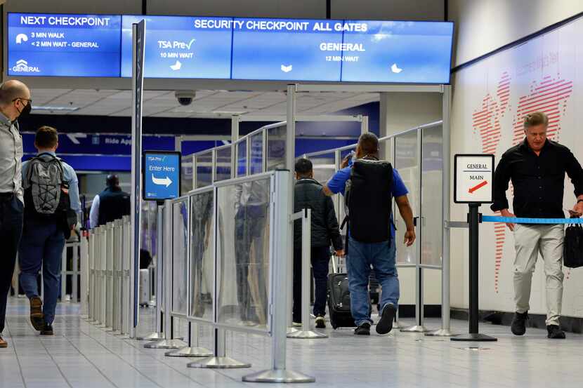 Travelers make their way toward a TSA security checkpoint inside Terminal C at DFW...