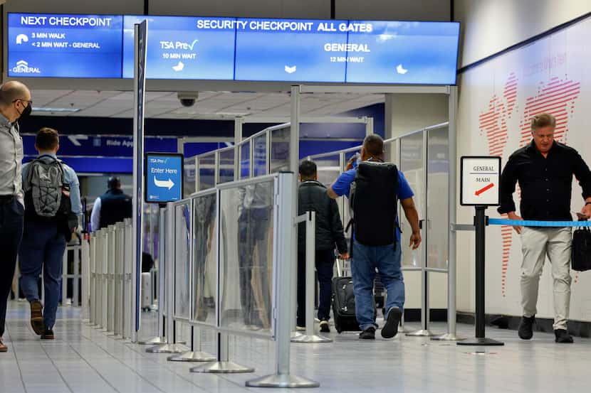 Travelers make their way toward a TSA security checkpoint inside Terminal C at DFW...