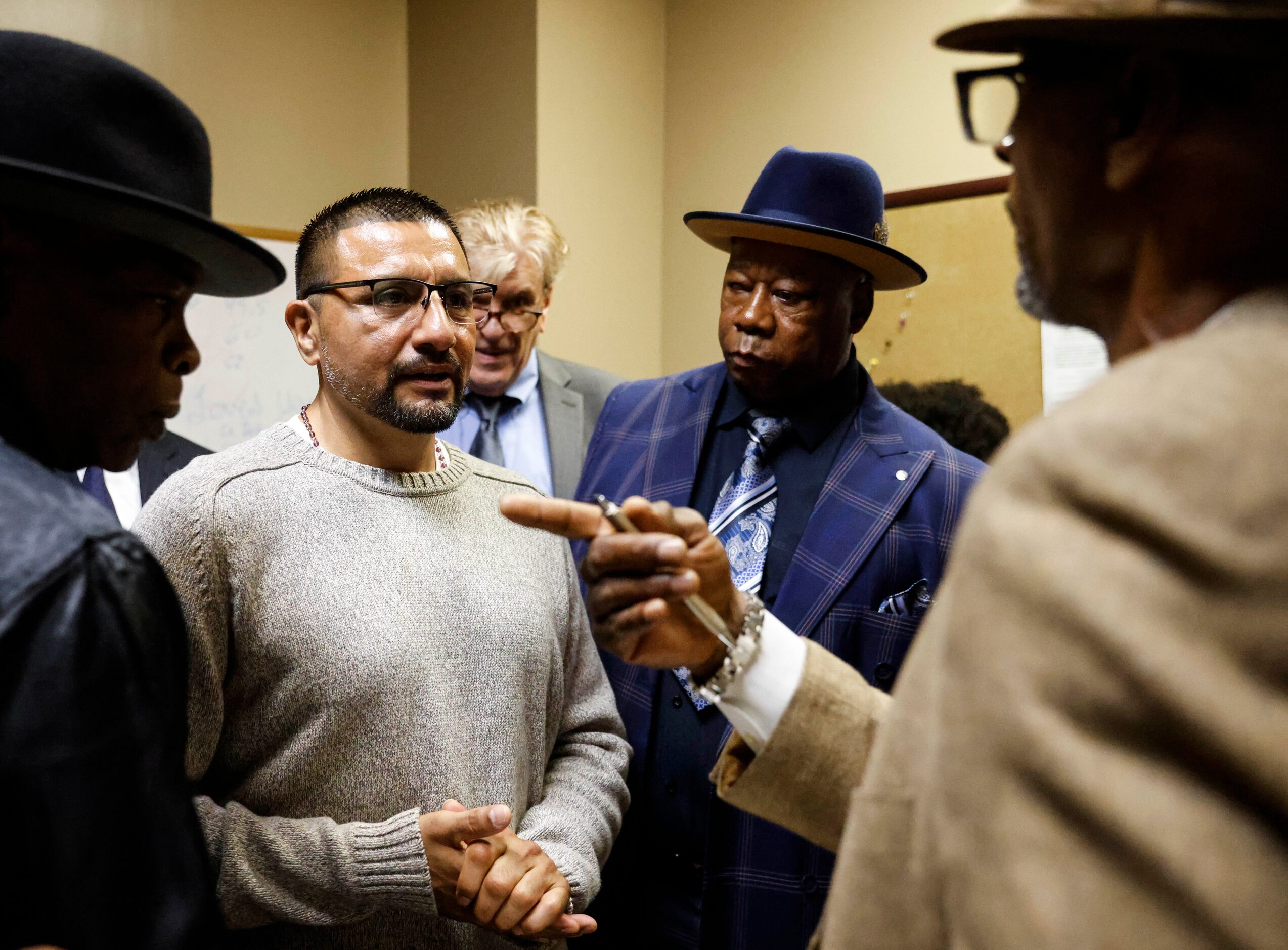 Martin Santillan (center) talks with other exonerees, including Johnny Pinchback (right),...