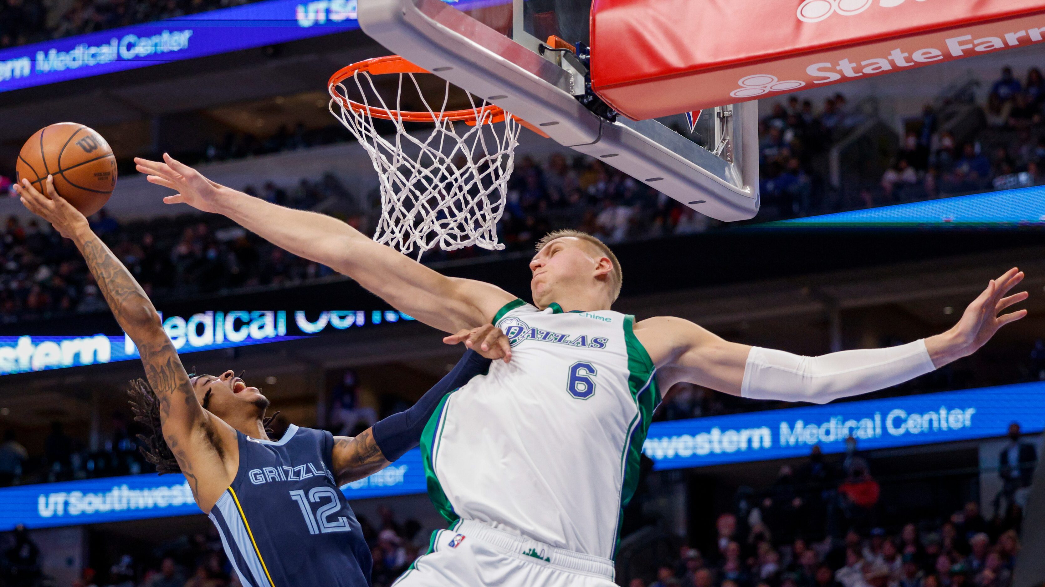 Dallas Mavericks center Kristaps Porzingis (6) stretches to try and block a shot by Memphis...