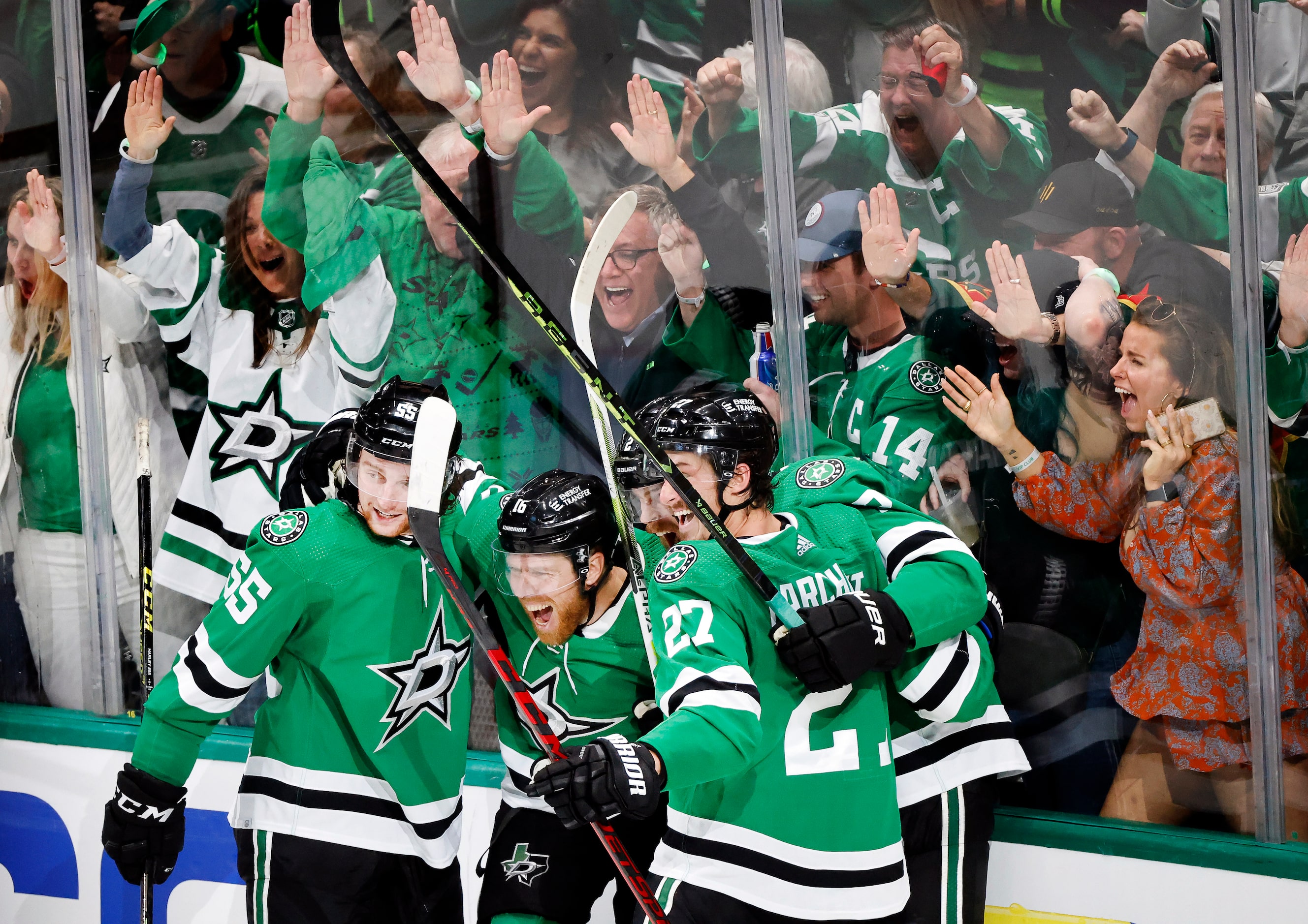 Dallas Stars center Joe Pavelski (16, center) is congratulated by teammates after his fourth...