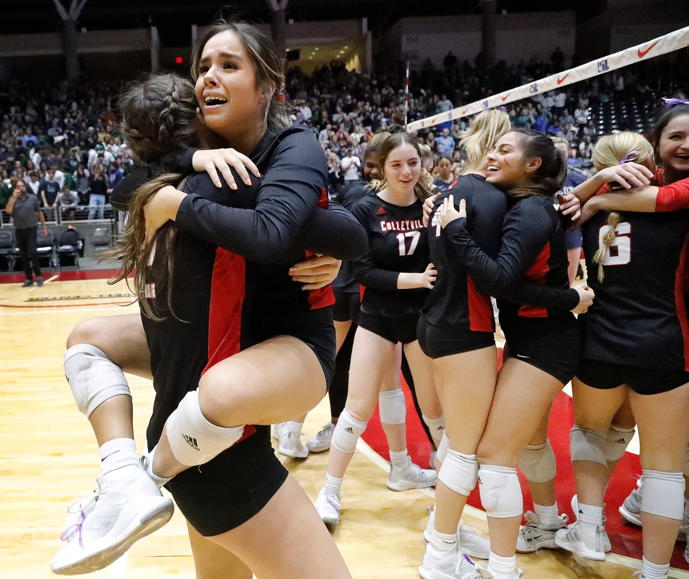 Colleyville Heritage High School's Mia Bogdos (2) holds  Alyssa Gonzales (1) as they embrace...