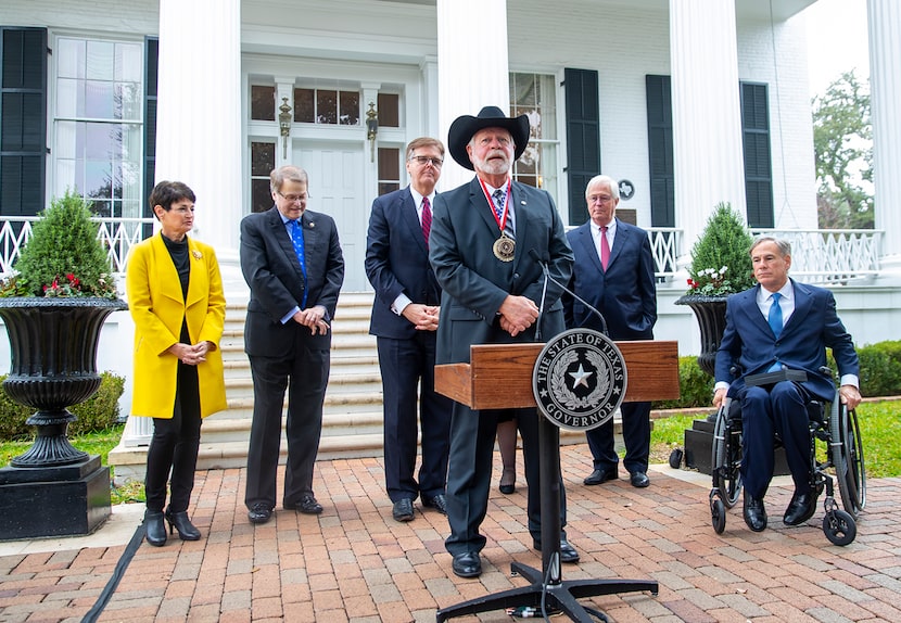 Gov. Greg Abbott, right, presented the Governor's Medal of Courage on Monday to Jack Wilson,...