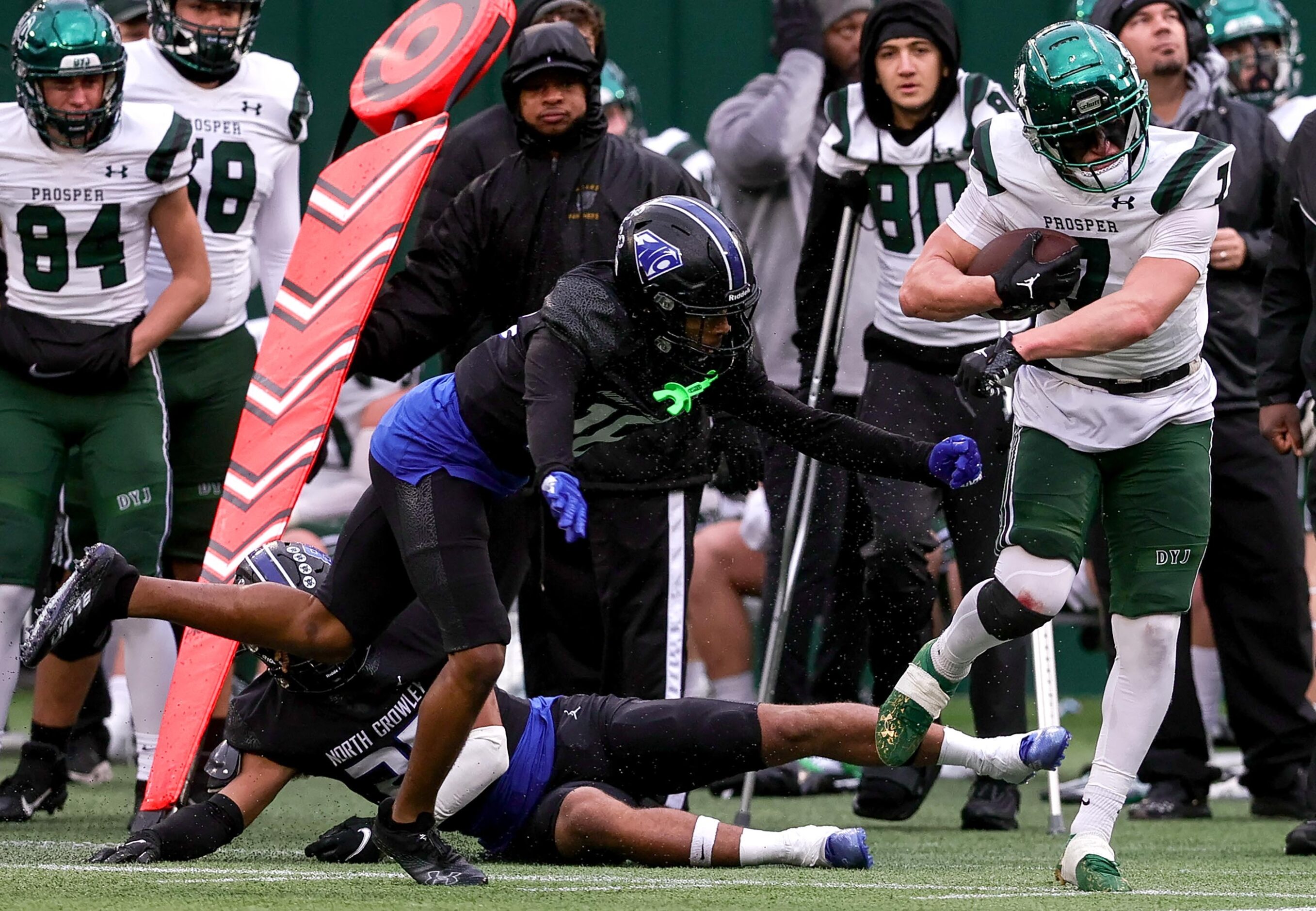 Prosper half back Brayden Rymer (7) tries to break a tackle from North Crowley defensive end...