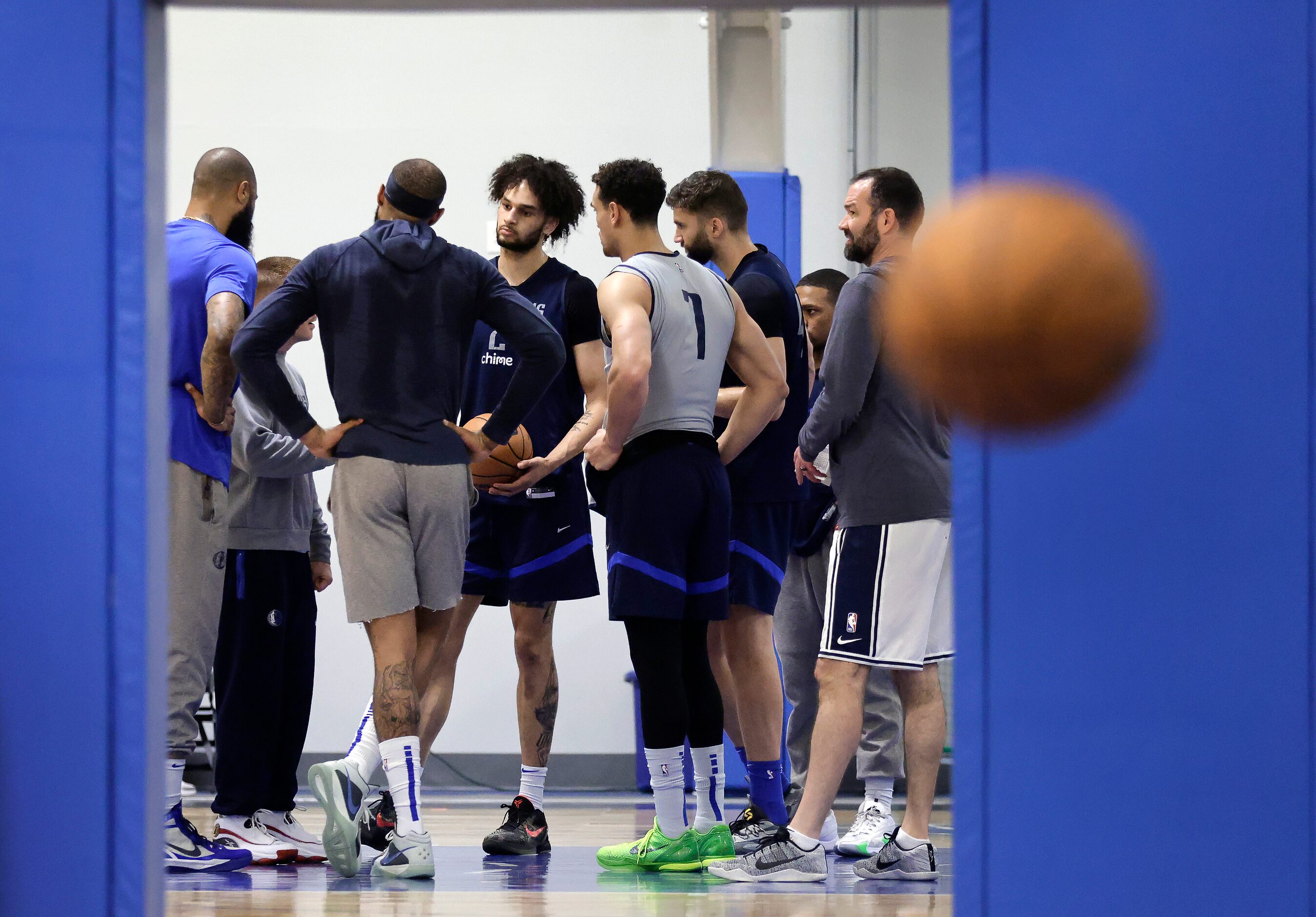 Dallas Mavericks big men, including center Dereck Lively II (center, facing), huddle on the...