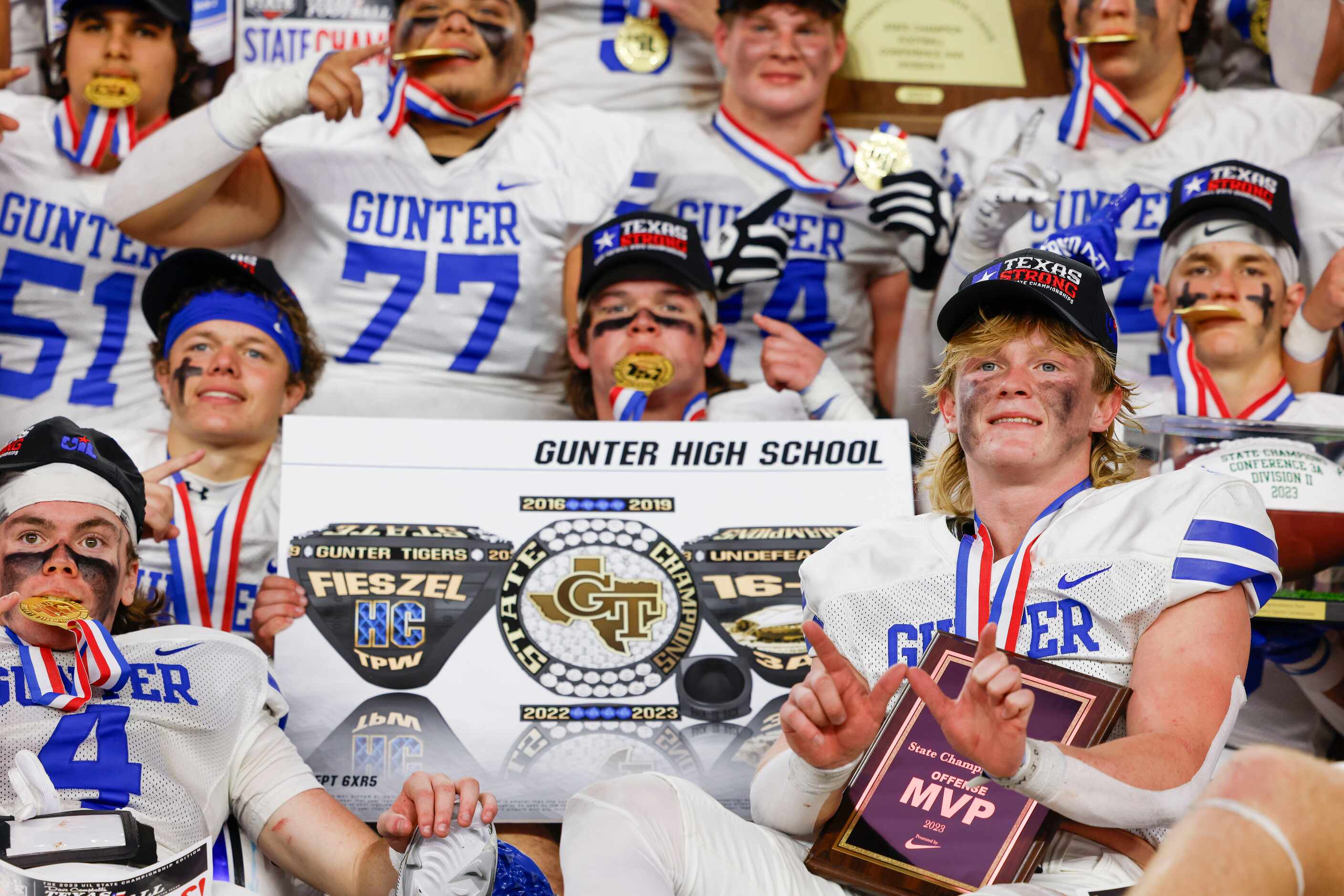 Gunter High players including QB Walker Overman (right) pose for a celebratory photo after...