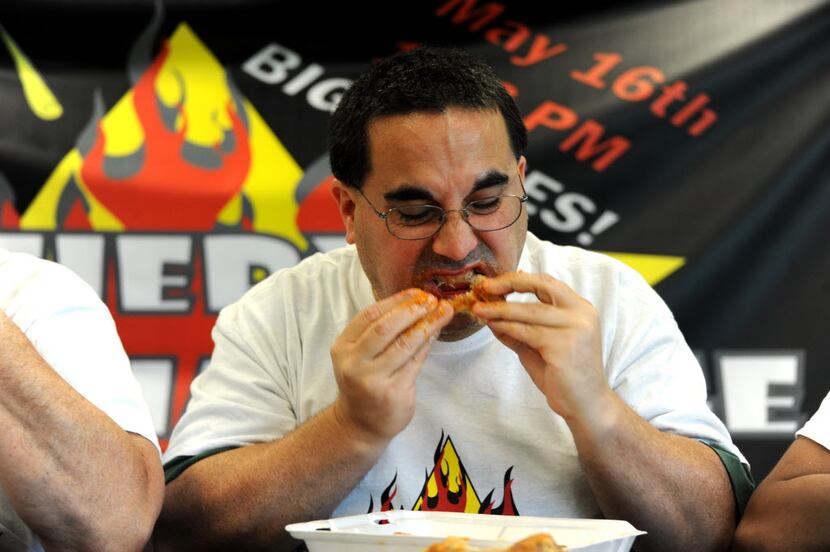 Jason Pick eats wings by Wing Town at the Taste of Irving Fiery Heat Challenge in Irving, TX...