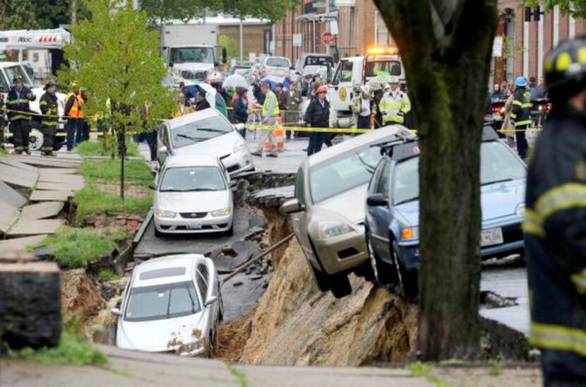 
Cars were perched on the edge of a sinkhole Wednesday in the Charles Village neighborhood...