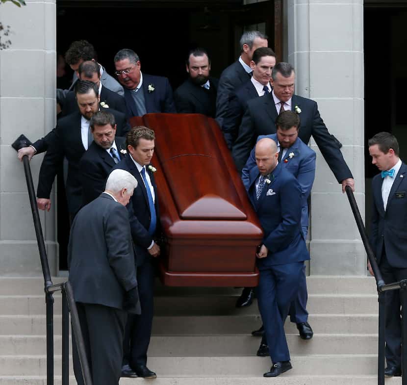 Pallbearers — including Dallas County Judge Clay Jenkins (right, second from top) — carried...