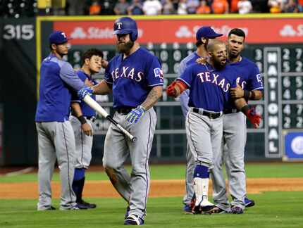 FILE - Mike Napoli, center, walks away as Rougned Odor, right, is restrained by Robinson...
