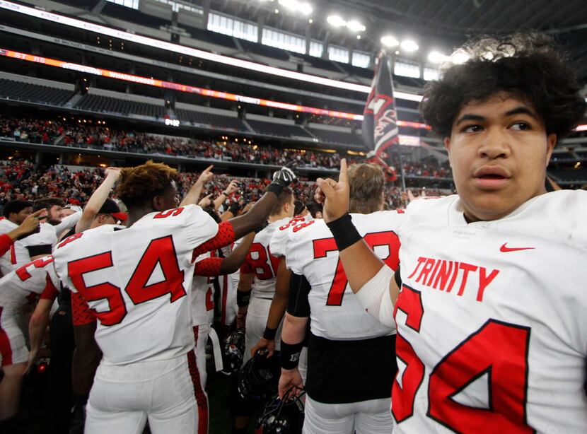 Euless Trinity offensive lineman David Toutai (64) takes in the moment during the playing of...