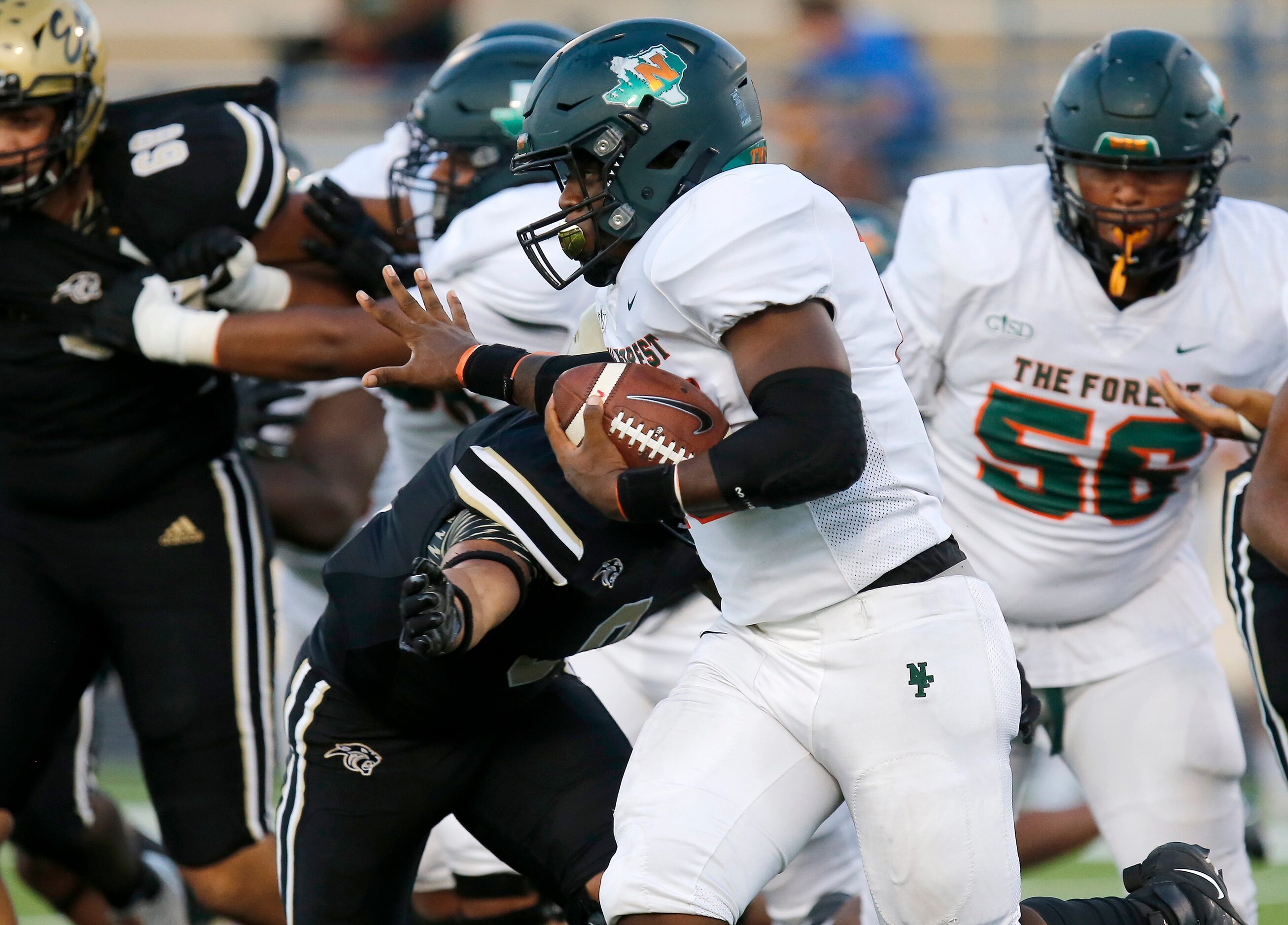 Naaman Forrest High School running back Isaiah Cunning (10) stiff arms Plano East Senior...