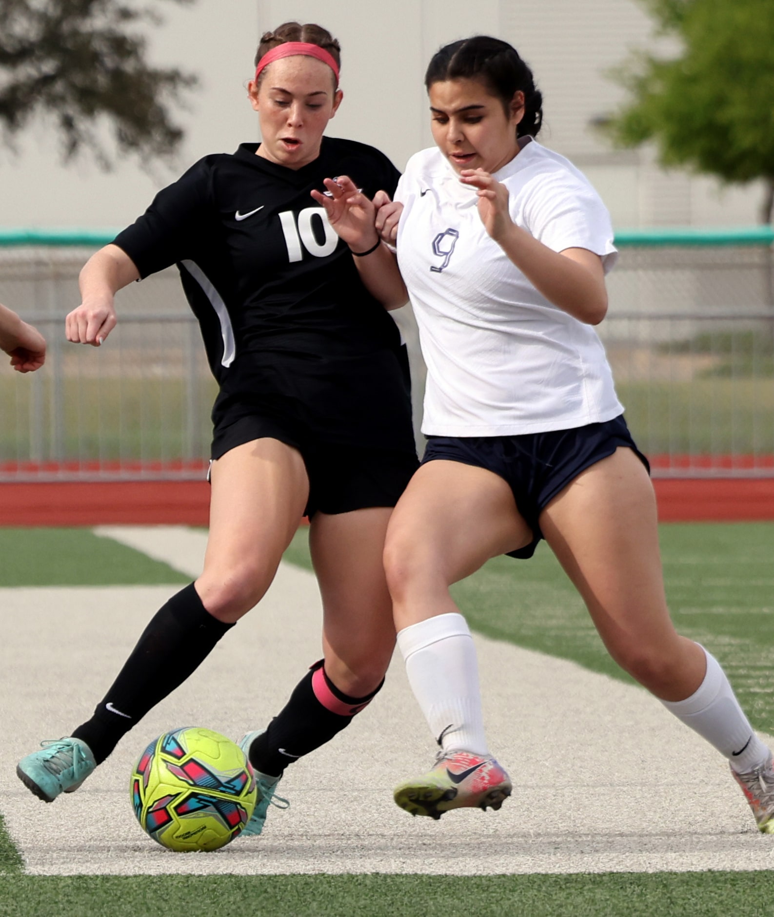 Flower Mound Marcus midfielder Allie Williams (10) controls the ball as Richardson JJ Pearce...