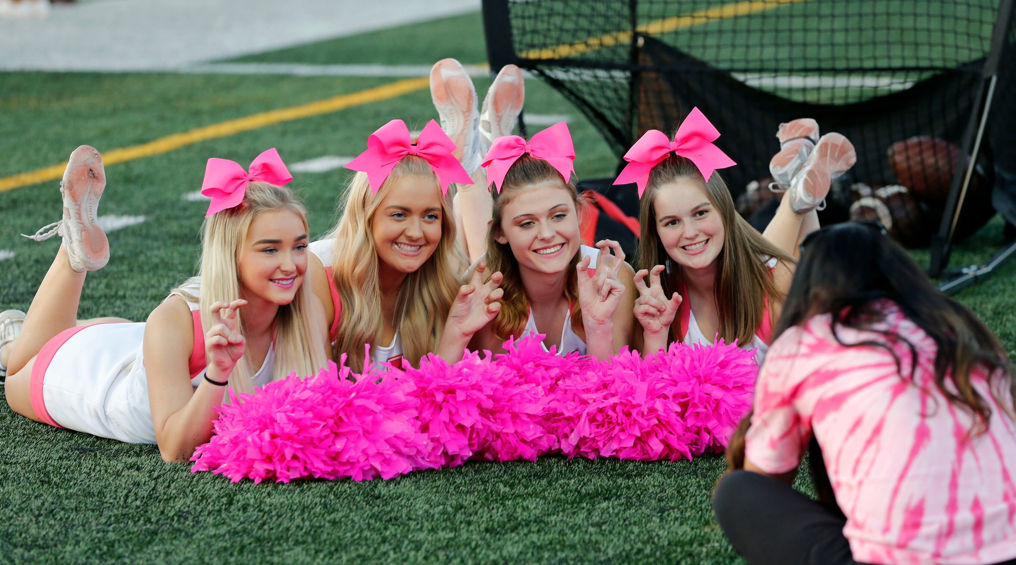 A group of Rockwall Heath cheerleaders pose for a photo before the start of a high school...