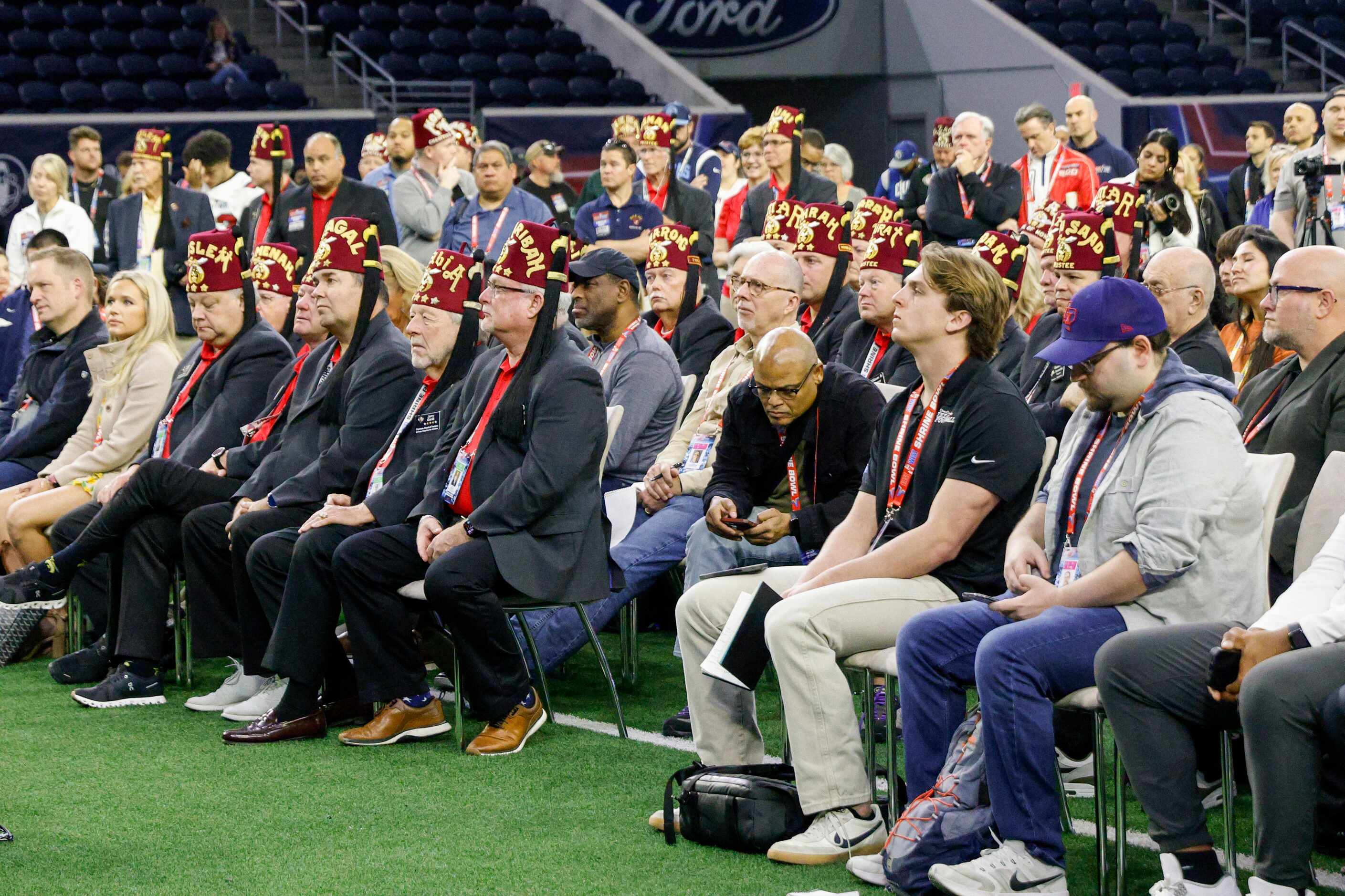 Shriners and members of the media watch as former NFL wide receiver Steve Smith and Texas...