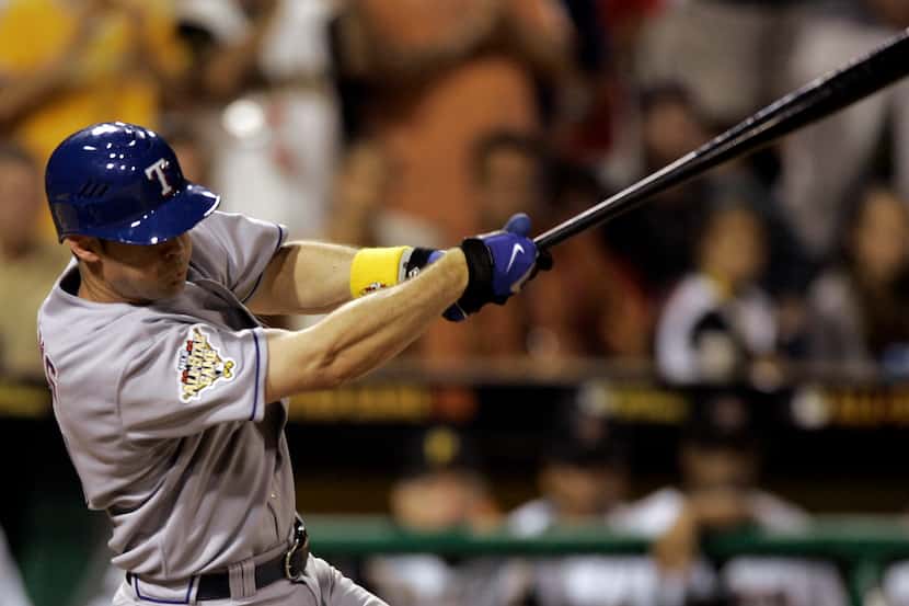 American League's Michael Young of the Texas Rangers triples to center off National League's...
