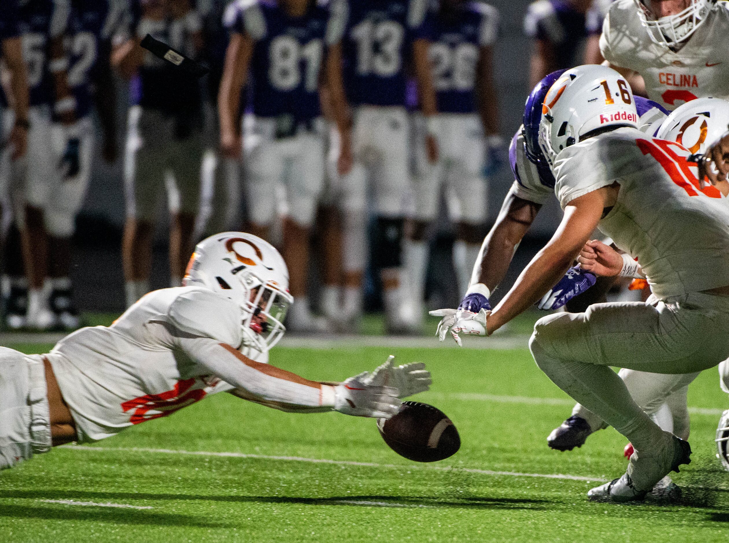 Celina’s Cade Biagini (10) recovers a fumble in the first half during a high school football...