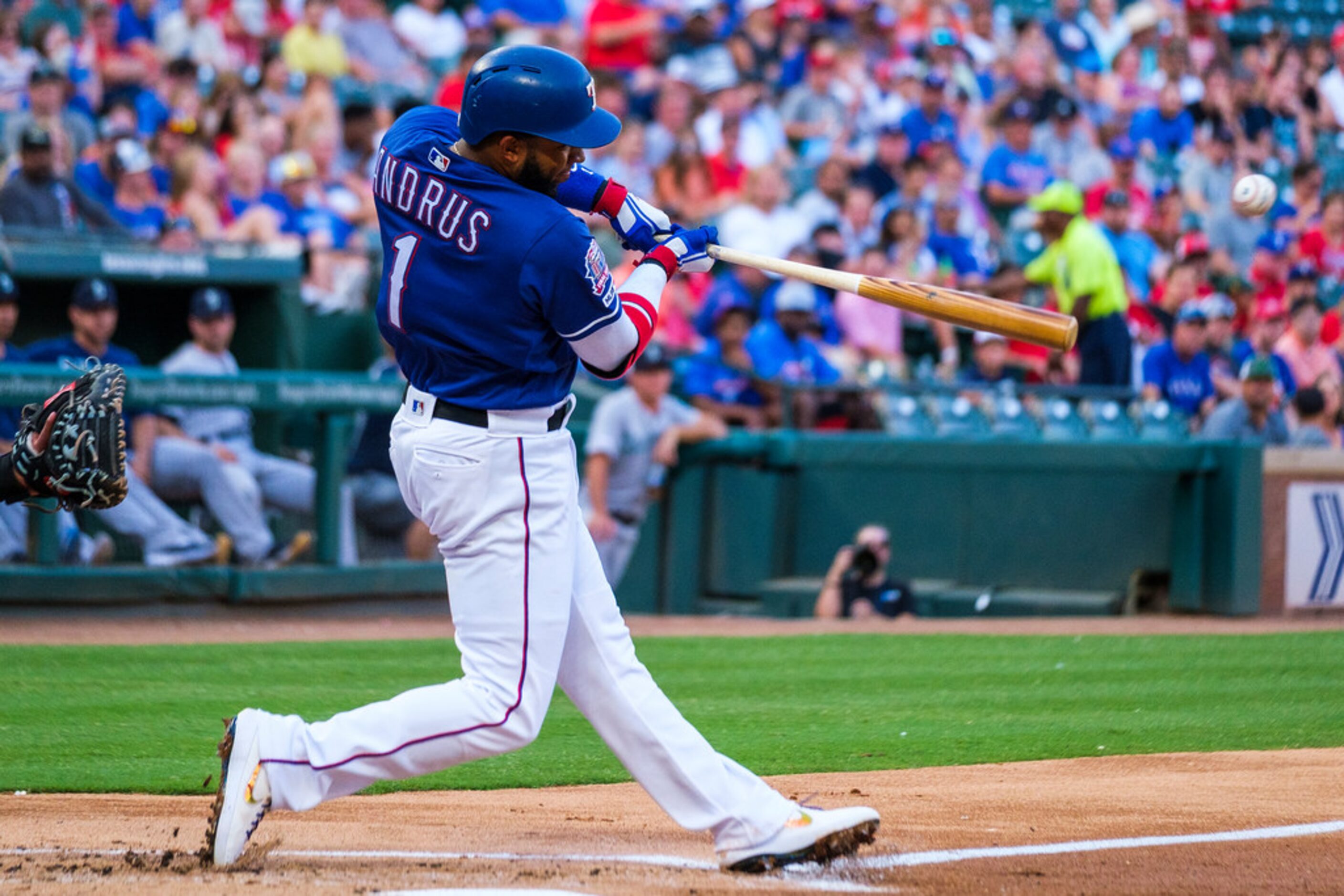 Texas Rangers shortstop Elvis Andrus hits a single during the first inning against the...