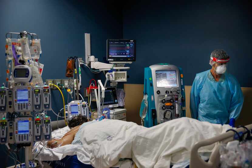 Dr. Matt Leveno assesses an intubated patient as he does daily rounds checking in on the...