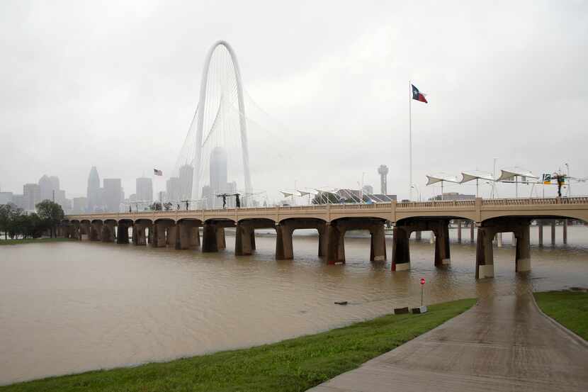 As rain continued to fall Monday, the Trinity River near downtown Dallas continued to rise.