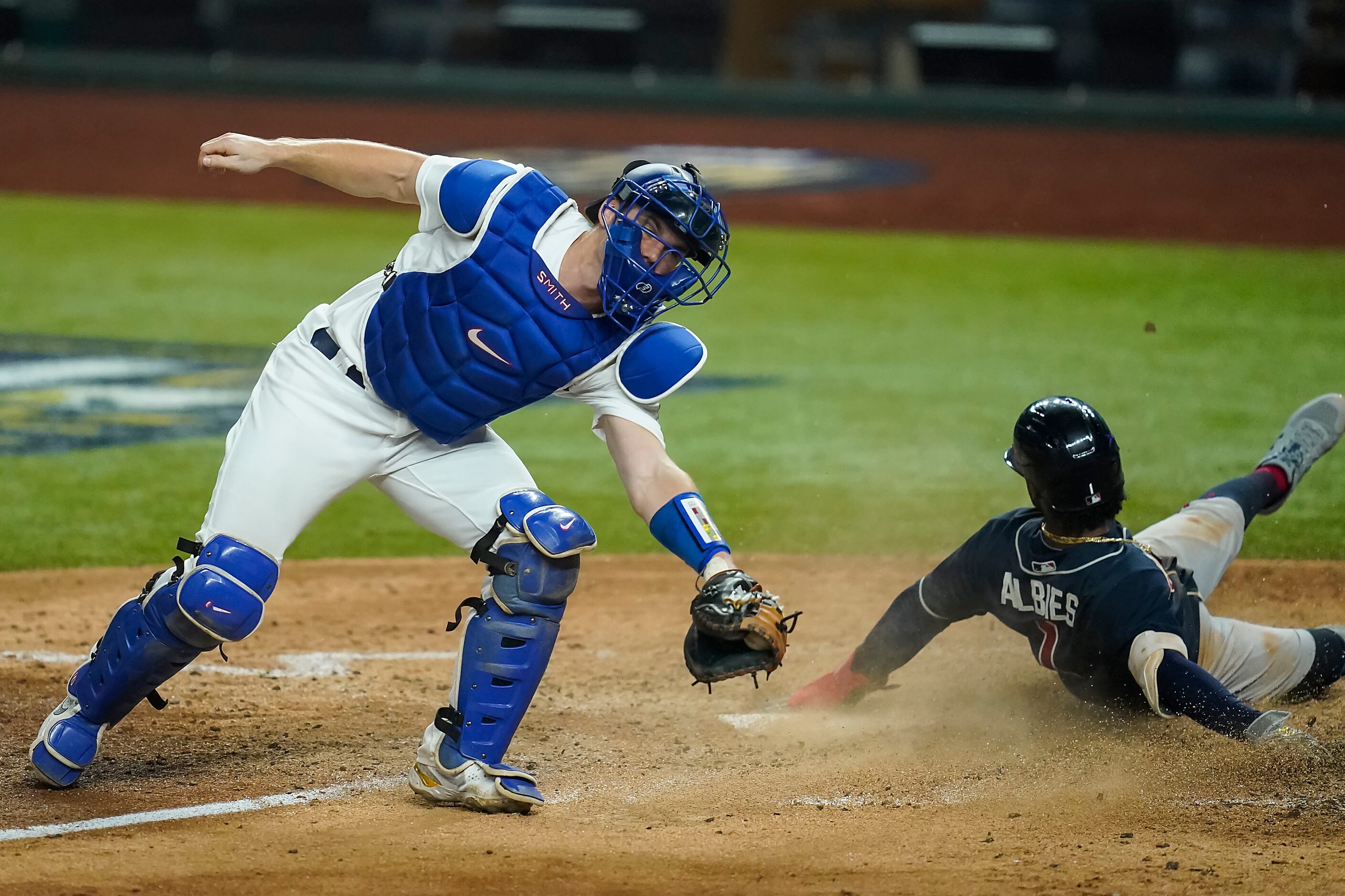 Atlanta Braves second baseman Ozzie Albies (1) scores past Los Angeles Dodgers catcher Will...