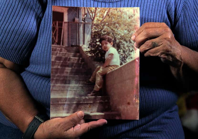 Bessie Rodriguez, the mother of Santos Rodriguez, holds a photograph of her son in her...