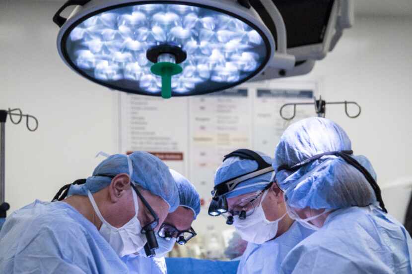 Surgeons at Baylor University Medical Center in Dallas performing the first uterine...