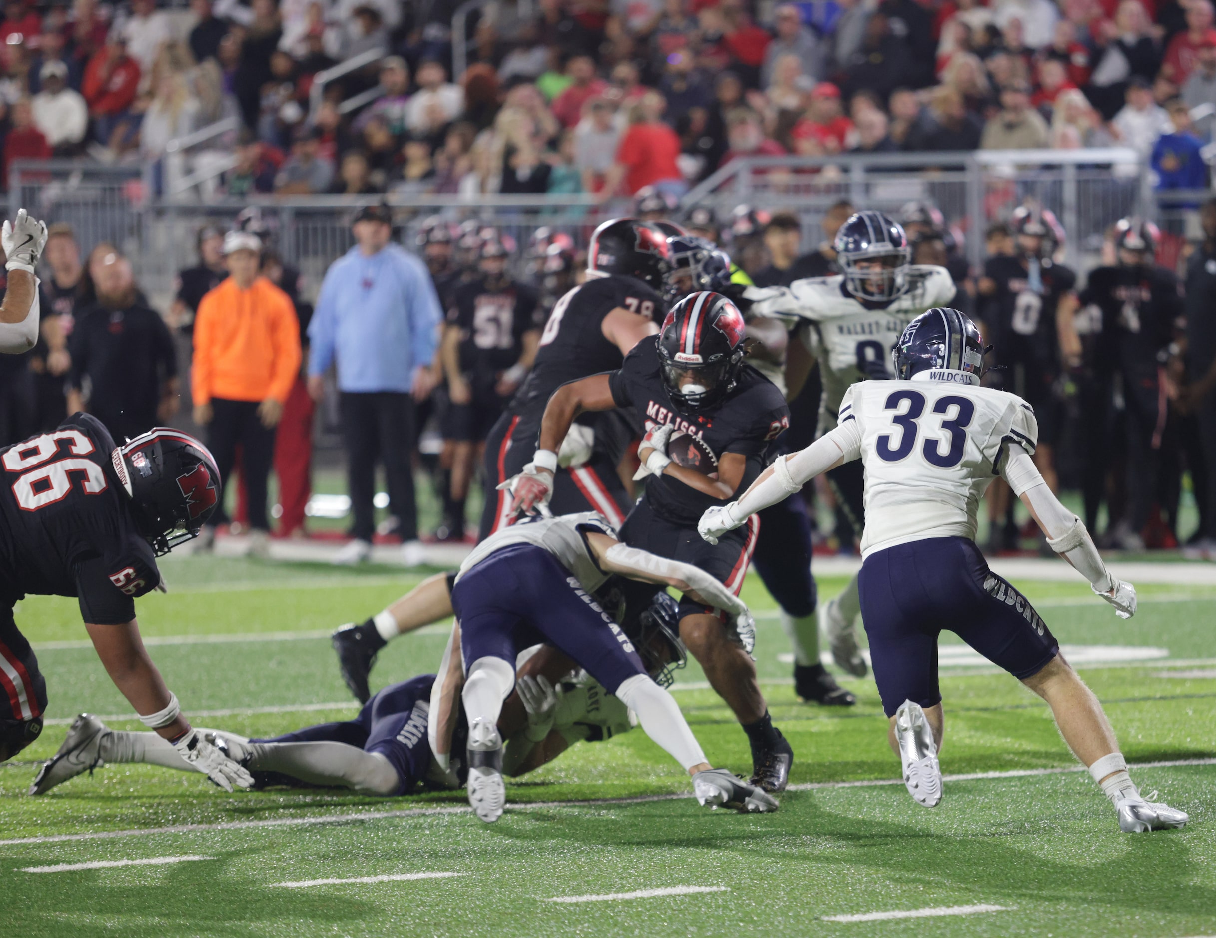 Melissa player #22 Jeremiah Tabor runs into a defensive wall during the Prosper Walnut Grove...