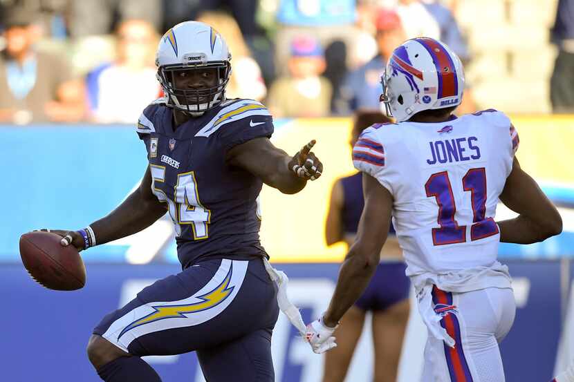 Los Angeles Chargers outside linebacker Melvin Ingram, left, scores a fumble return...