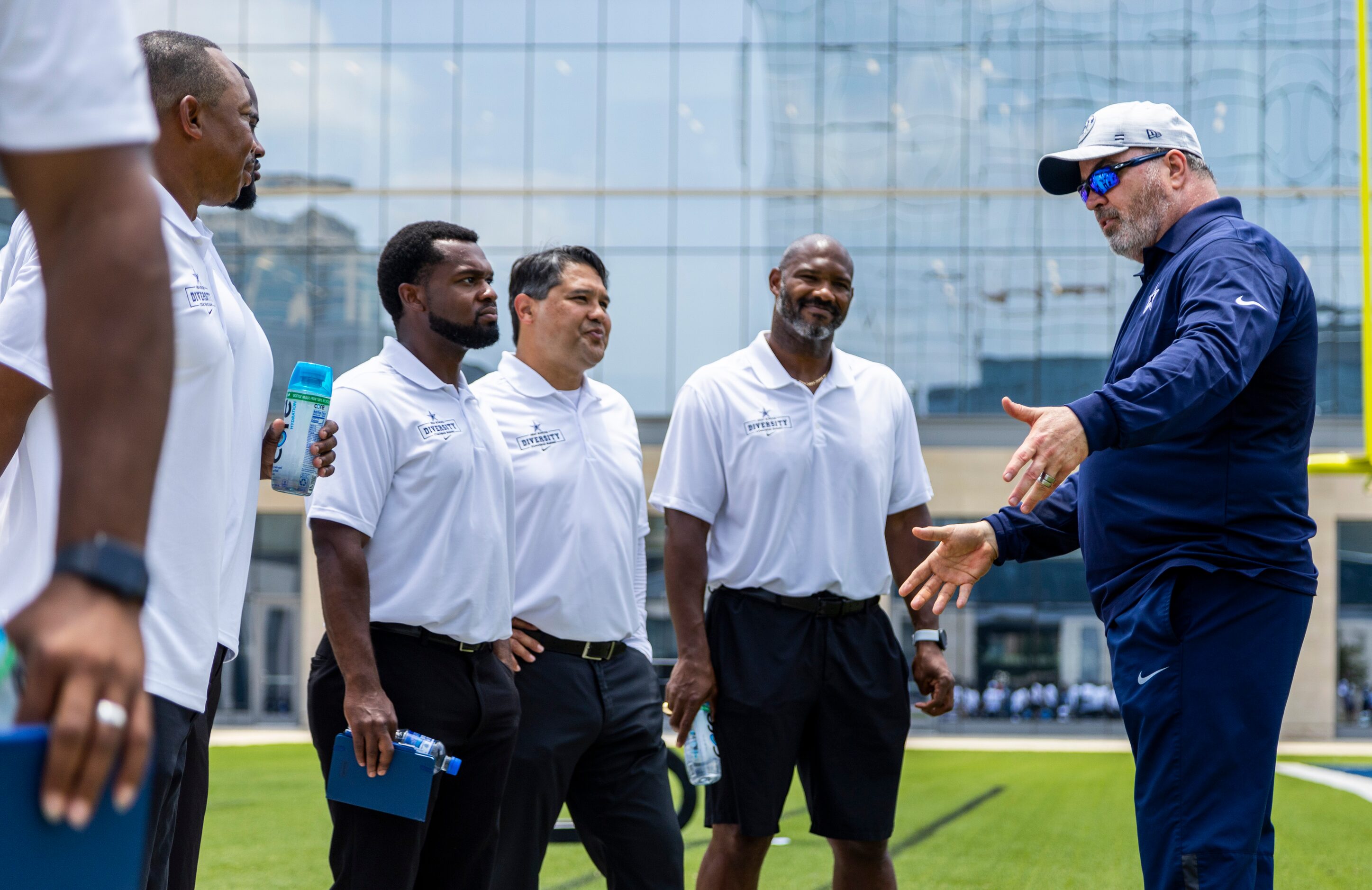 Dallas Cowboys head coach Mike McCarthy, right, speaks with Texas high school football...