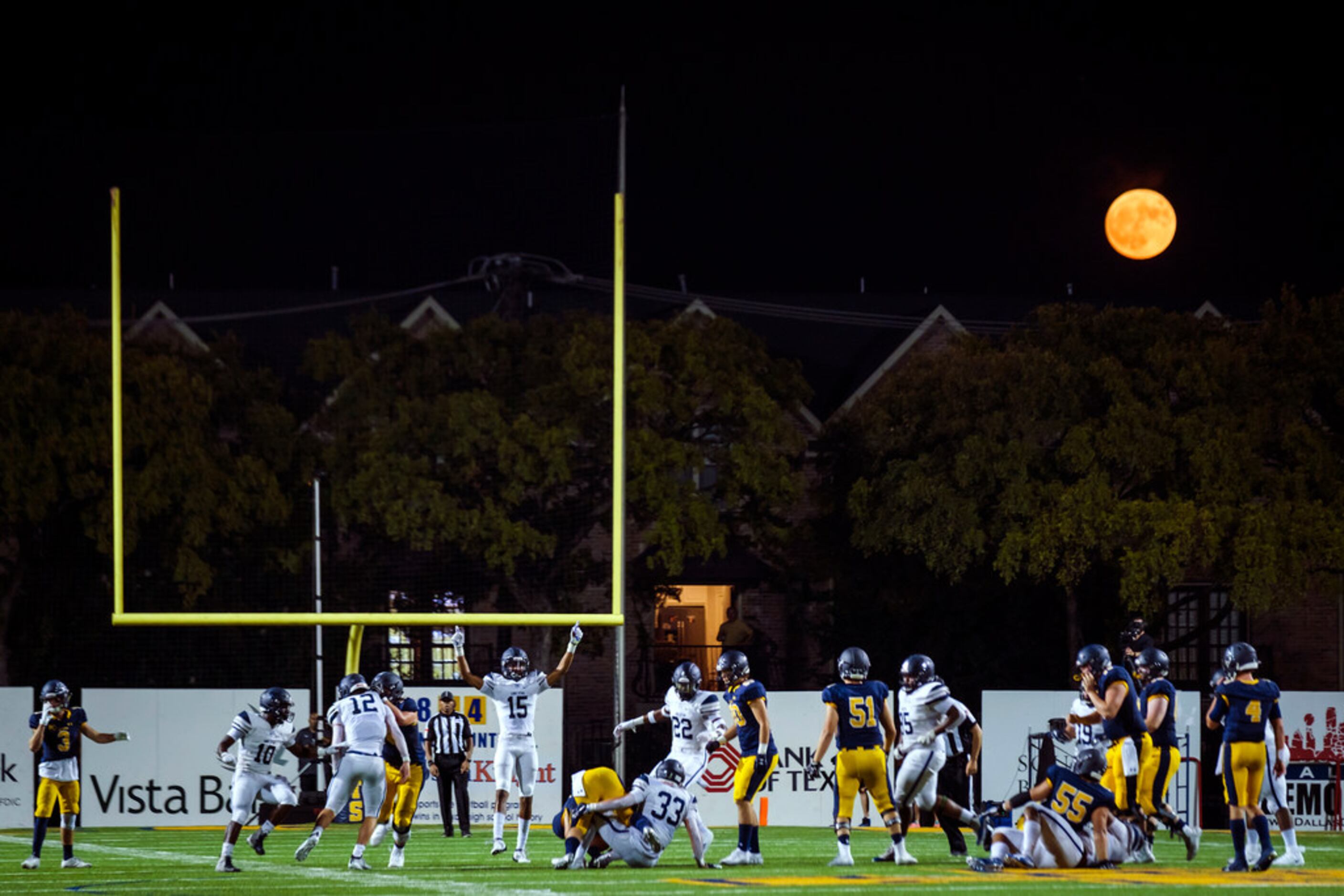 The full moon rises over he stadium as Frisco Lone Star faces Highland Park in a high school...