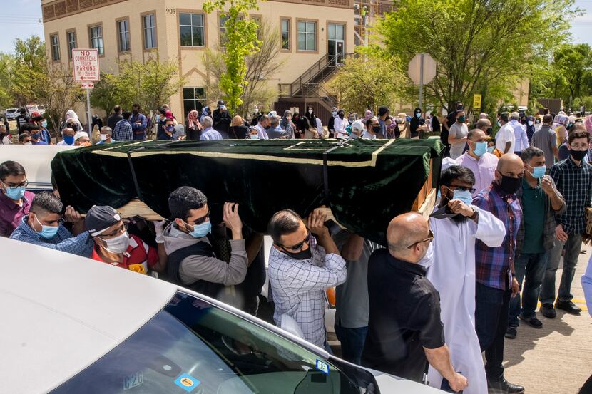 Men at the Islamic Association of Allen carried the caskets Thursday of the six family...