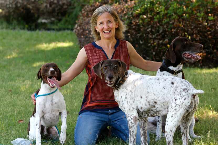 Andrea Laurent-Simpson with her dogs, Tickles (left), Sadie and Sam (right) in their yard in...