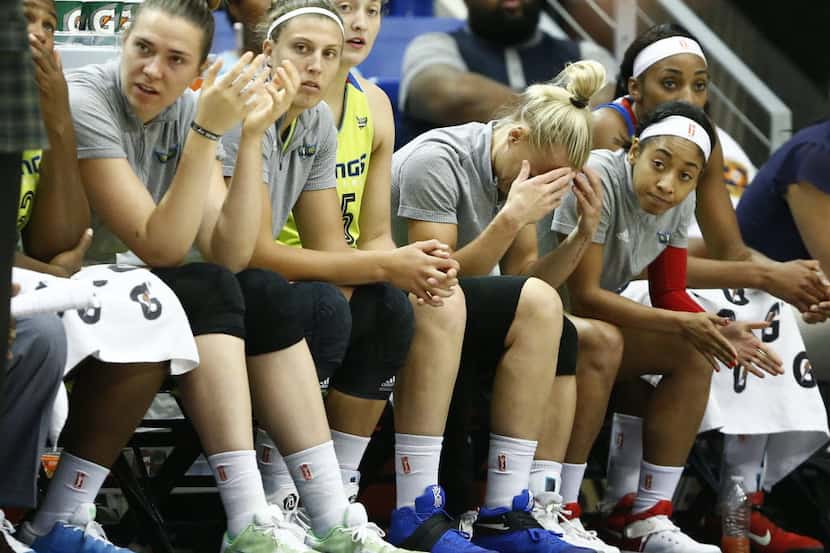 Dallas Wings players looks on from the bench during a WNBA basketball game between the...