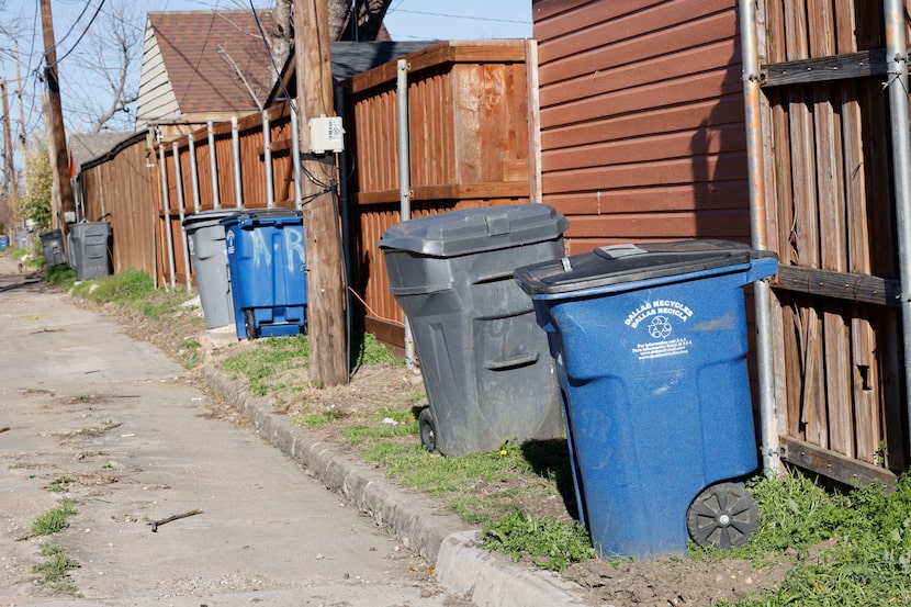 Trash cans are seen on the alley between Bowman Boulevard and Chireno Street, Thursday, Feb....