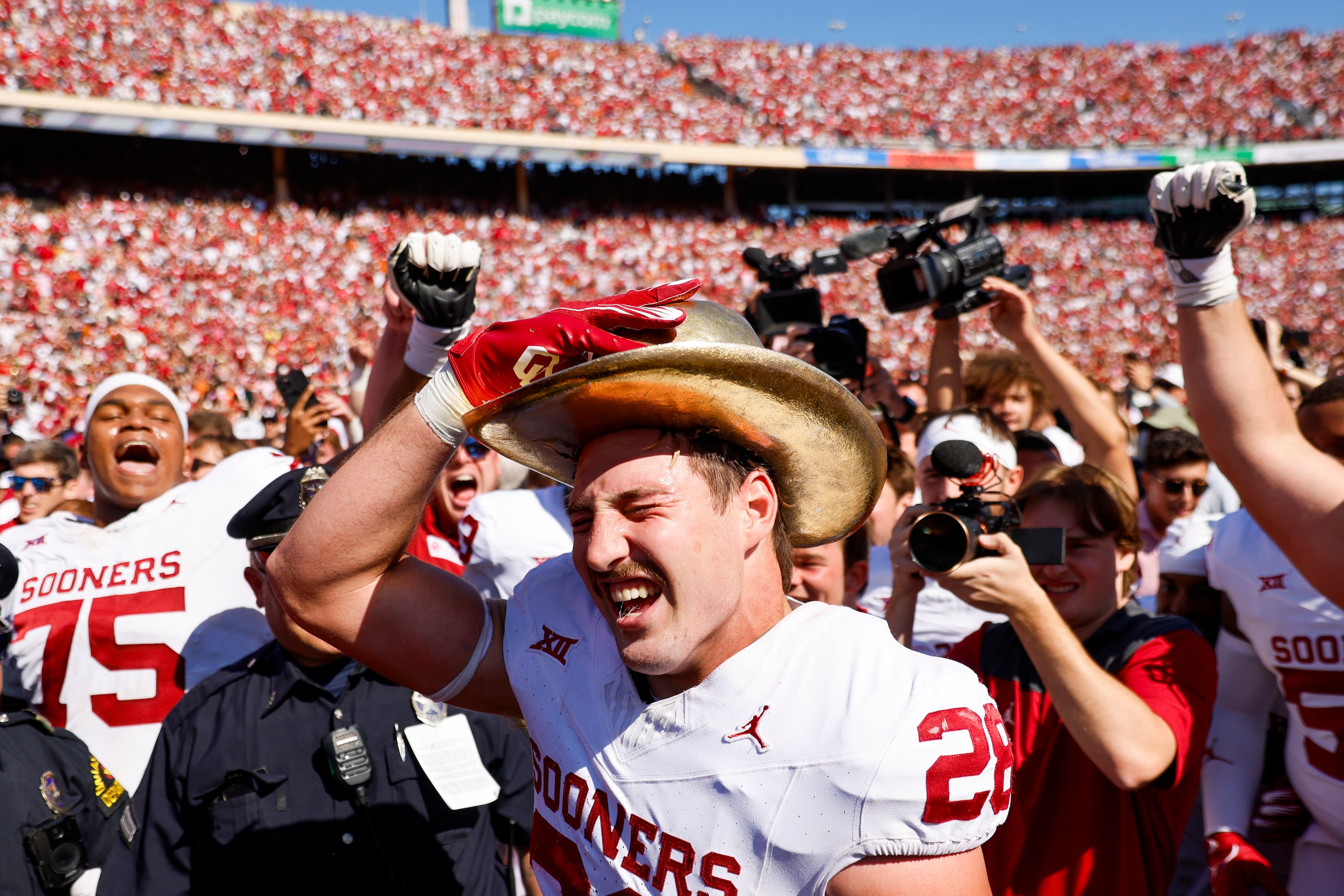 Oklahoma linebacker Danny Stutsman wears the gold hat after winning the Red River Rivalry...