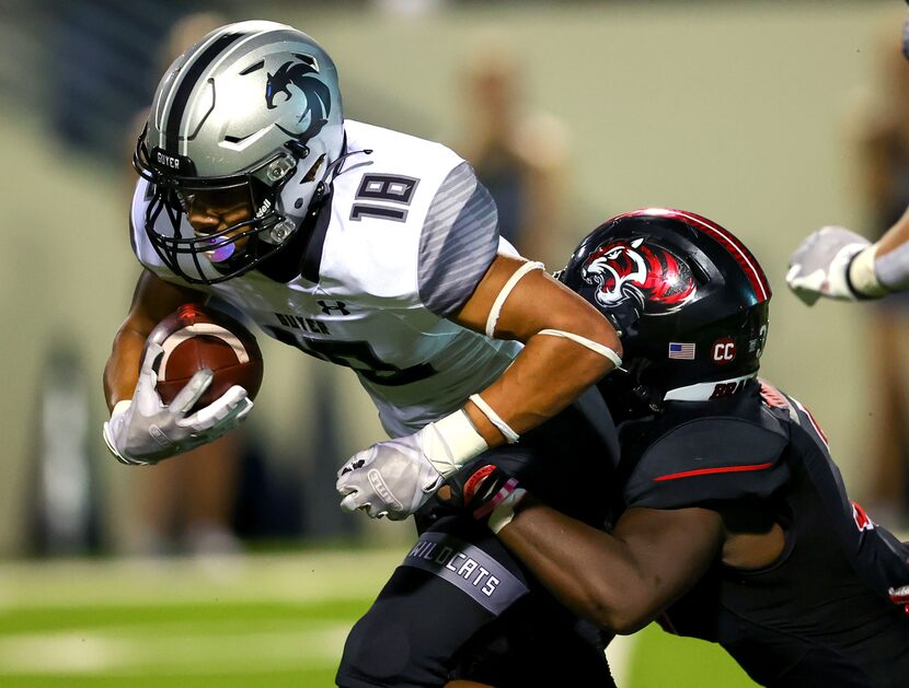 Denton Guyer kick returner Eli Bowen (18) is tackled by Denton Braswell linebacker Alan...