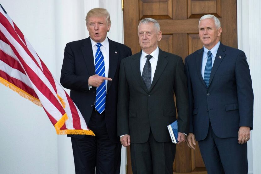 U.S. President-elect Donald Trump stands with U.S. Marines General (Ret.) James Mattis, whom...