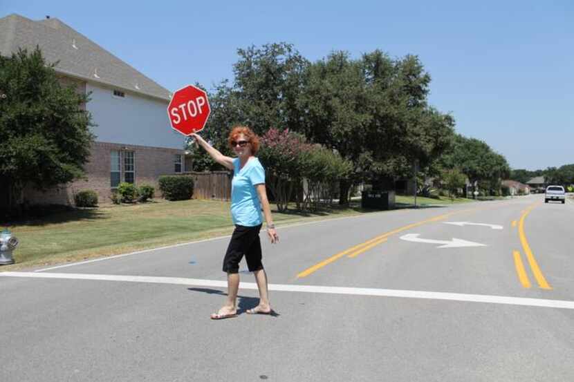 
JoAnn Rogers walks across Briarhill Boulevard at her new full-time post for McAuliffe...